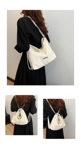 Detail of off-white woven texture bag with silver heart buckles and dual-use straps