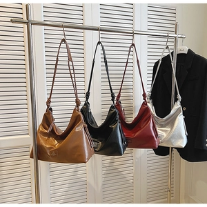 Detailed row of four textured PU leather hobo bags in brown, black, red, and silver finishes
