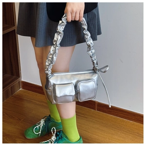 Detail of silver metallic PU shoulder bag with dual pockets and scrunchie pleated strap