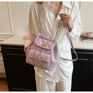Detail of lavender quilted backpack with gold chain straps and twist lock closure