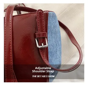 Detail of adjustable silver buckle and blue denim with red patent leather strap