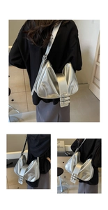 Close-up of three metal buckles on the adjustable strap of a silver metallic shoulder bag