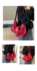 Detail of red patent leather shoulder bag with multiple buckle straps and ruched design