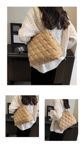 Detail of the high-quality quilted texture and gold chain strap on the beige tote bag