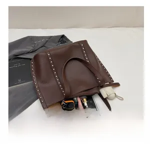 Large dark brown tote bag showing internal storage for umbrella, phone and tablet