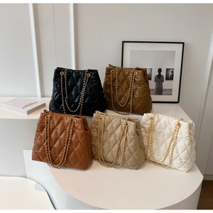 Detailed view of five quilted chain bags in black brown caramel beige and white colors