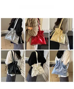 Detail view of ballet-style drawstring tote bags in six colors with bow decorations