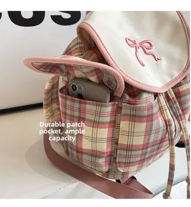 Pink checkered canvas backpack featuring a durable side pocket for large smartphone storage