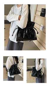 Detail of black glossy tote bag with ribbon accents and drawstring closure for daily use