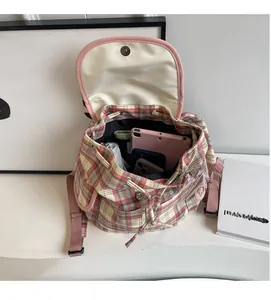 Interior view showing large capacity and drawstring closure of pink plaid backpack
