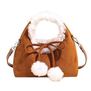 Brown faux suede dumpling bag with white faux fur trim and fluffy pompom charms
