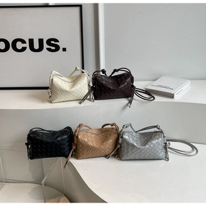 Detail shot of woven leather crossbody bags in five colors with knot shoulder strap details