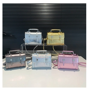 Close-up of metallic crinkle messenger bags in gold, silver, and bronze finishes