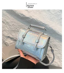 Close-up of aurora silver holographic leather messenger bag with metallic hardware details