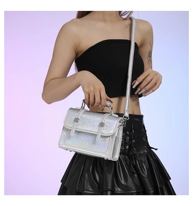 Close-up of holographic messenger bag with silver metallic finish on a model