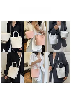 Detail of fashion bucket bag set with pearl chain and matching mini coin purse