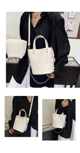 Detail of off-white bucket bag with silver studs and matching pouch set with metal chain