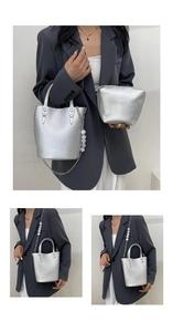 Detail of silver bucket bag with lychee texture, pearl chain strap and matching pouch