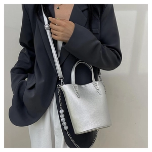 Detail of silver lychee grain bucket bag with decorative marble bead chain strap