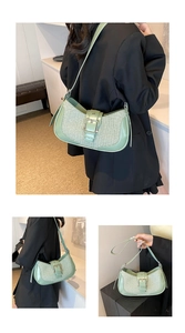 Detail of light green woven underarm bag with retro gold metal buckle and leather trim