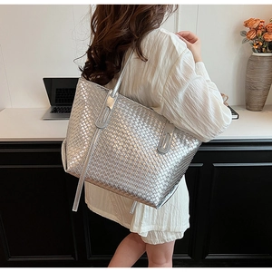 Detail of silver woven tote bag with metallic texture and large capacity design