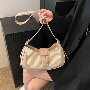 Detail of cream white underarm baguette bag with woven panel and silver buckle