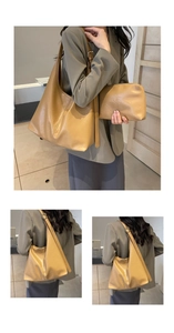 Detail view of large mustard yellow leather tote bag with matching zipper pouch set