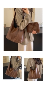 Detail view of dark brown pleated leather tote bag set with matching small pouch and metal buckle