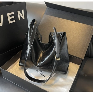 Sac fourre-tout noir brillant plissé présenté dans un coffret cadeau luxueux