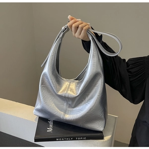 Detailed close-up of metallic silver pleated Hobo bag with textured synthetic leather finish