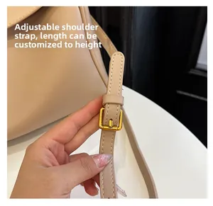 Detail of adjustable beige faux leather shoulder strap with gold buckle for tote bag