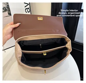 Top view of two-tone shoulder bag interior with dual compartments and zipper pocket