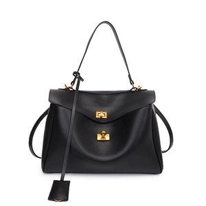 Elegant black leather top-handle bag with gold hardware and shoulder strap on white backdrop
