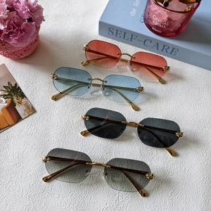 Frameless geometric rimless sunglasses set with gold leopard hardware and gradient lenses