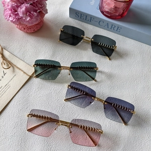 Fashion rimless cat eye sunglasses with metal rivet details and colorful tinted lenses