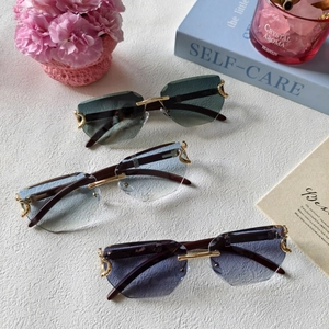 Close-up of rimless geometric sliced sunglasses with gradient lenses and C-shaped metal hinges