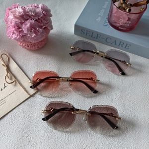 Fashionable rimless sunglasses with metal frame and diamond cut lenses for men and women
