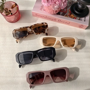 Retro thick rectangular sunglasses in various colors displayed in a lifestyle setting