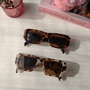 Close-up of retro square tortoise shell sunglasses with thick resin frames on a table