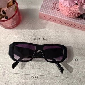 Fashionable oversized square sunglasses with black frame and purple gradient lenses