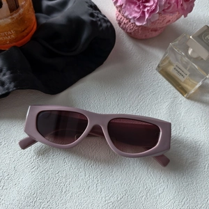 Rectangle lavender sunglasses with thick frames and dark lenses on a luxury backdrop