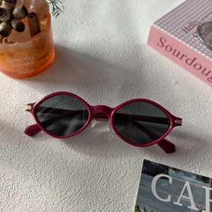 Retro burgundy geometric sunglasses with dark grey lenses and gold hinge accents