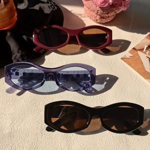 Three retro oval sunglasses in burgundy, black and purple monogram lens with thick frames