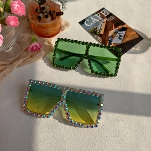 Detail of oversized square sunglasses with sparkling rhinestones and gradient lenses