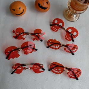 Halloween frameless resin sunglasses with pumpkin and skull shapes on white background