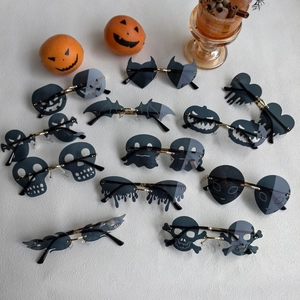 Close-up of novelty Halloween sunglasses with pumpkin and skull shaped resin lenses