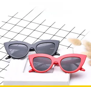 Chic oversized cat eye sunglasses in glossy black and red frames with dark lenses