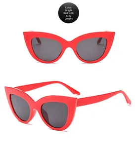 Detail view of fashion cat eye sunglasses in bright red frame with dark grey lenses