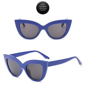 Detail view of cat eye sunglasses featuring deep blue frames and grey lenses