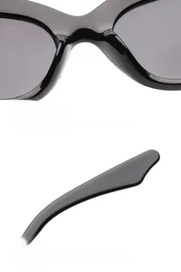 Detail of ergonomic integrated nose pads and curved temples on black cat-eye sunglasses